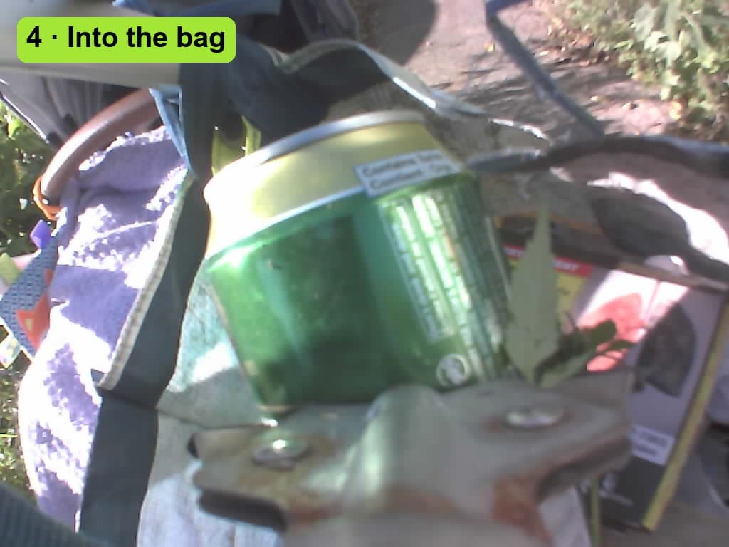 The beer can held over the open collection bag on the stroller, about to be dropped in.