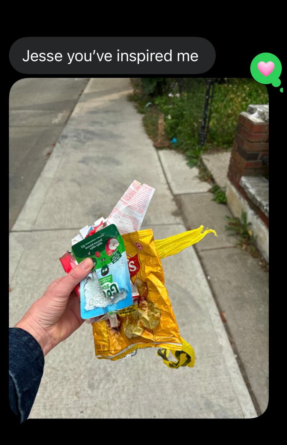 A text from a friend reading “Jesse you’ve inspired me”, with a photo of a handful of wrappers picked up from a sidewalk.